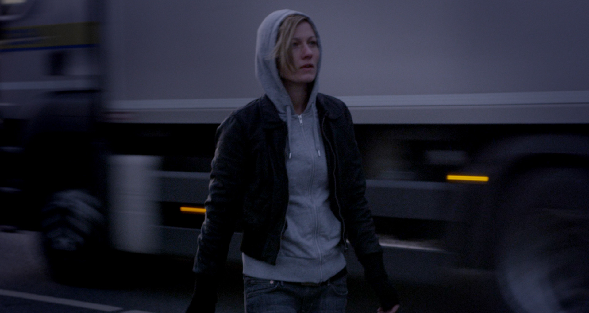 Lana Cooper in front of an fast moving truck