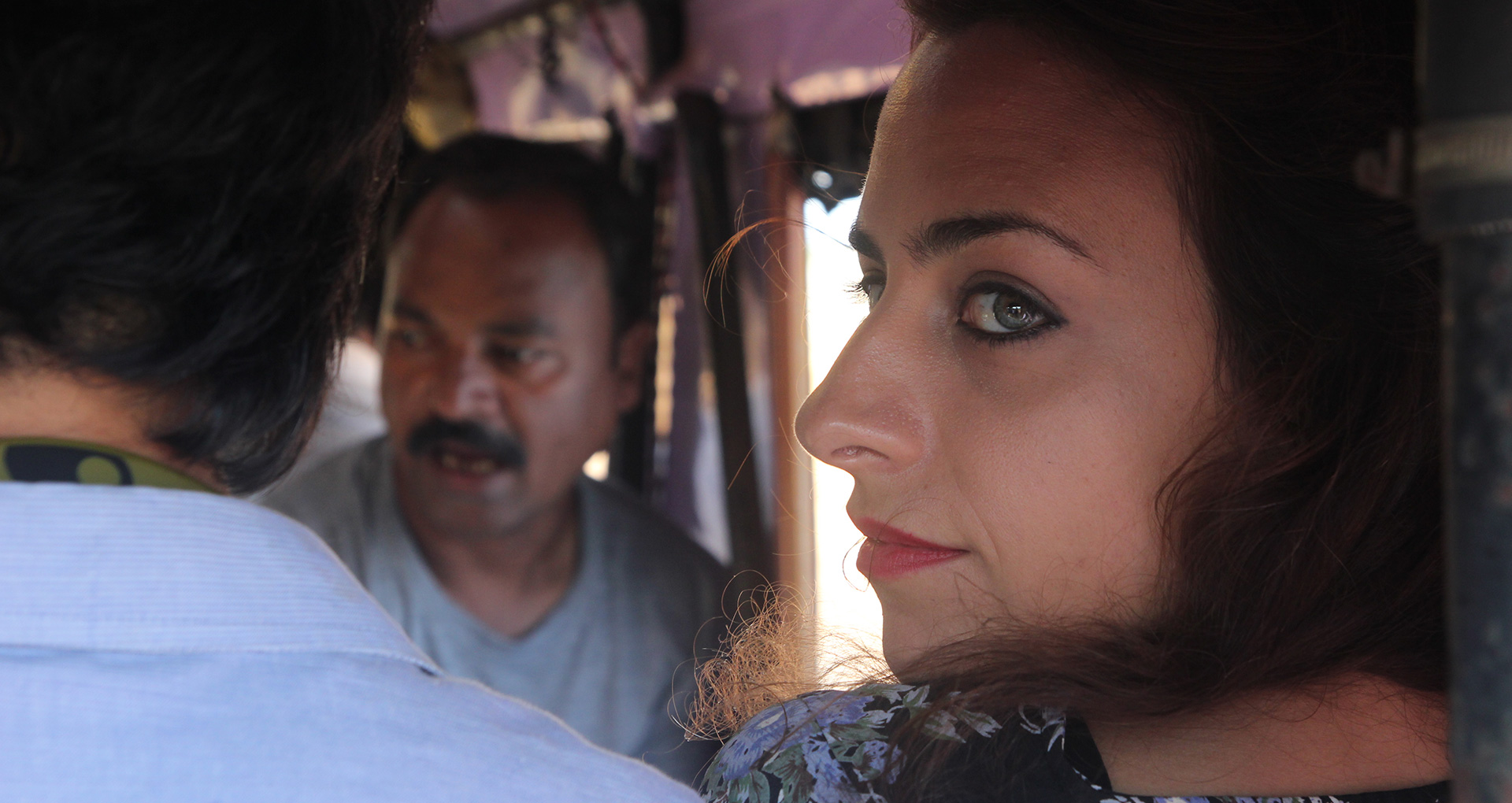 the young woman look back out of an tuk tuk
