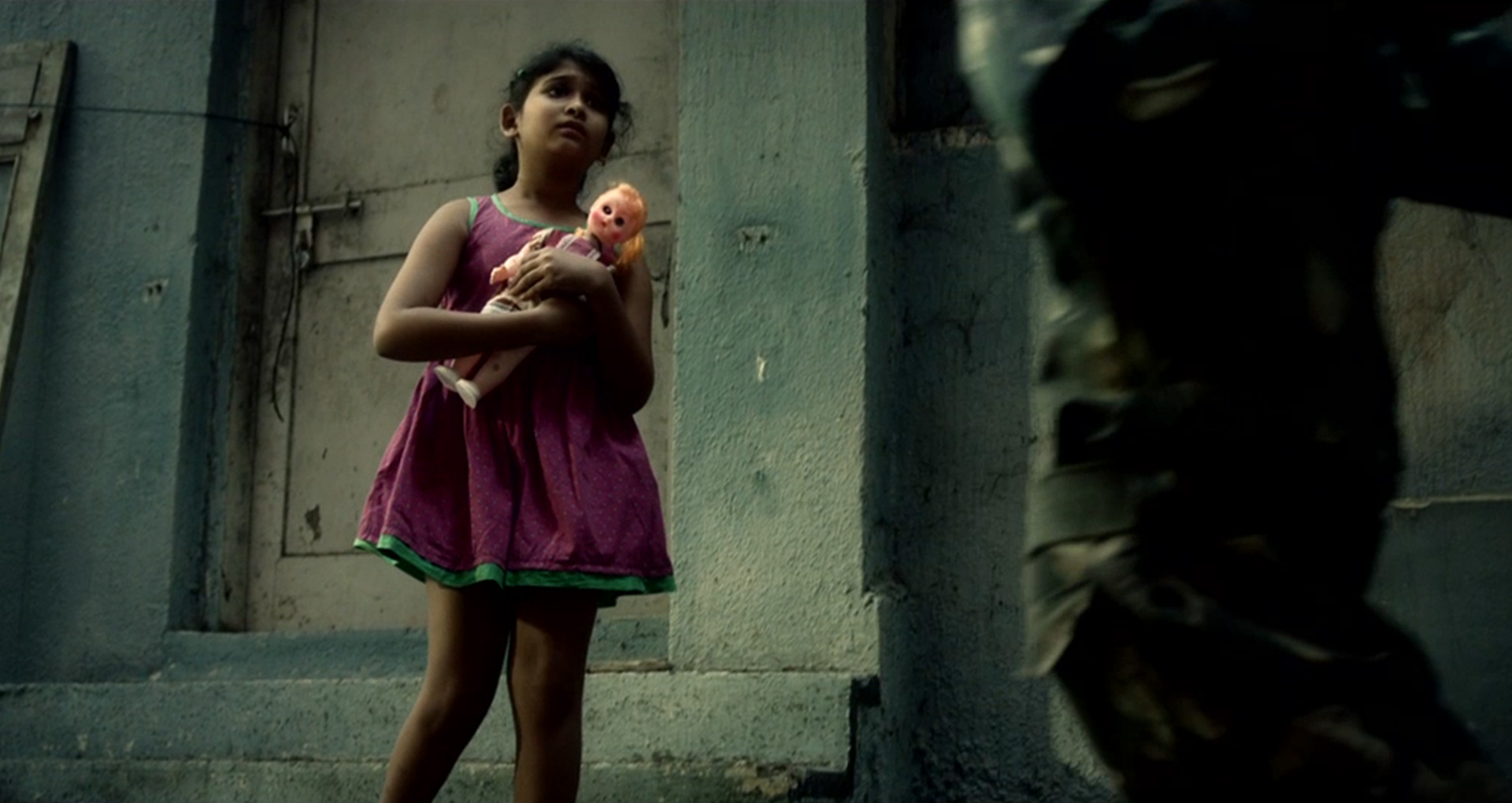young girl with a doll in her hands look up to an soldier